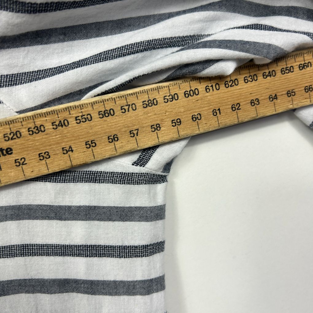 White and grey striped fabric with measuring tape detail view