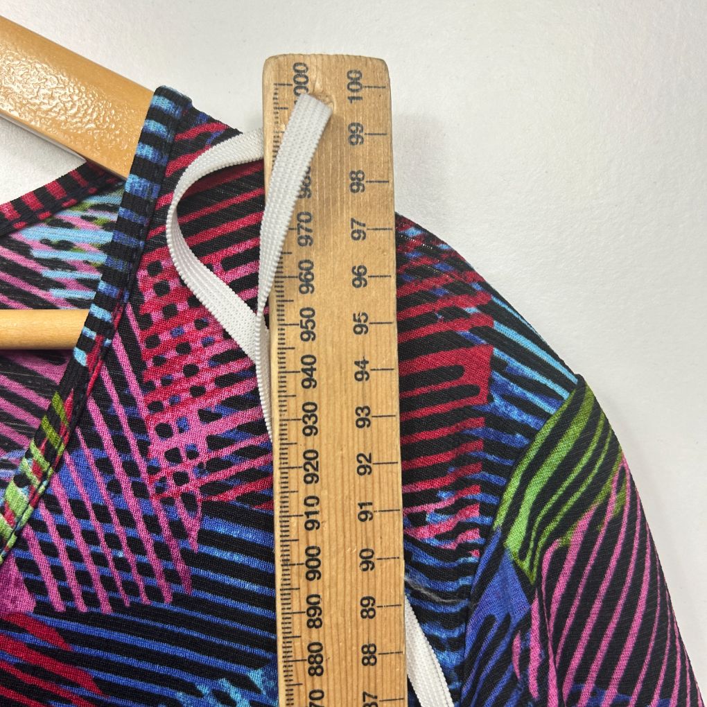 Colorful striped and geometric patterned fabric with measuring tape detail view