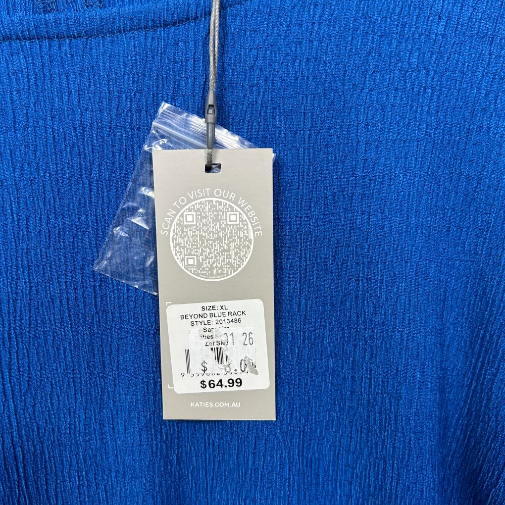 Blue ribbed knit garment label detail view