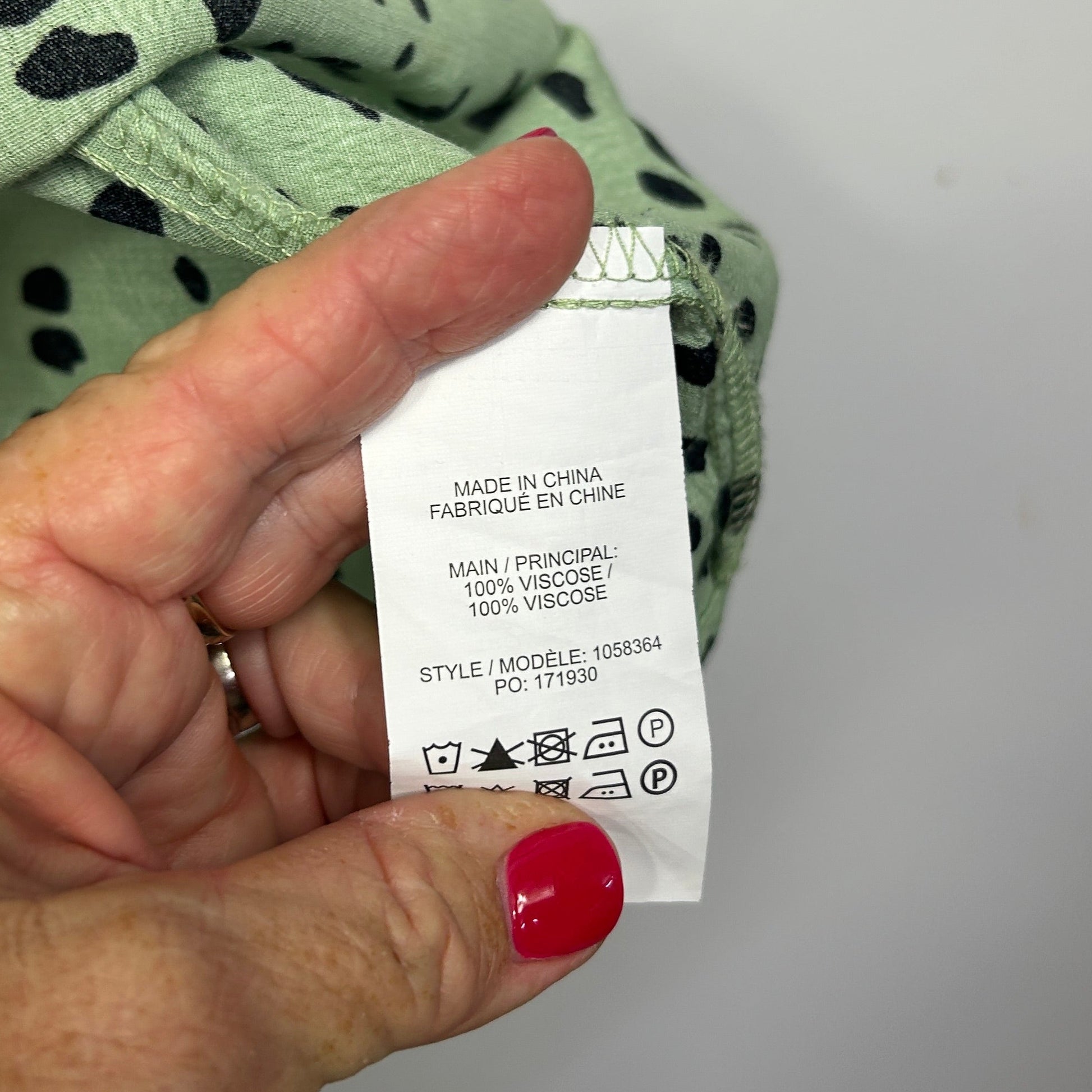 Green top with black leopard print detail view of label