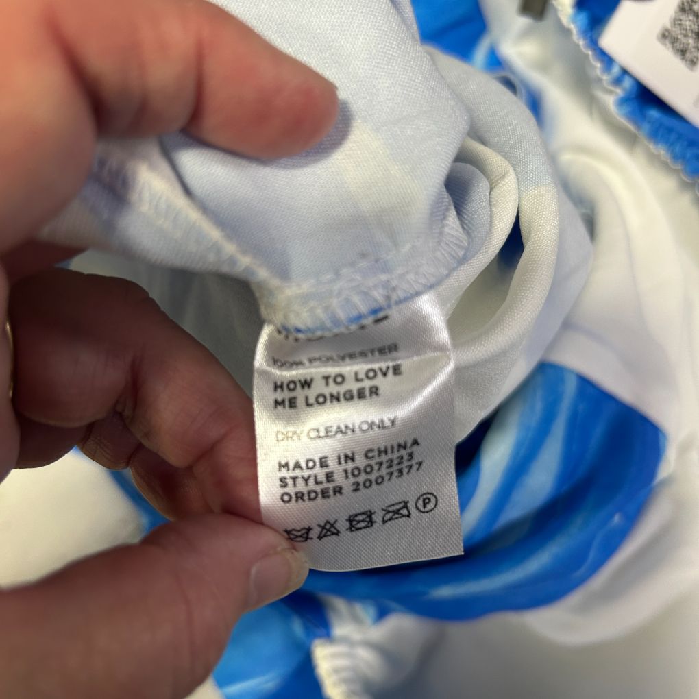 White and blue clothing label detail view