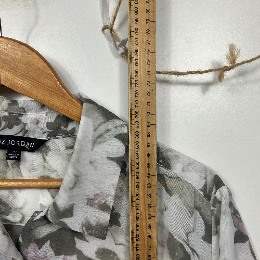 Grey floral shirt front view with wooden hanger and measuring tape