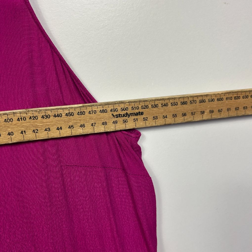 Purple dress detail view with measuring tape