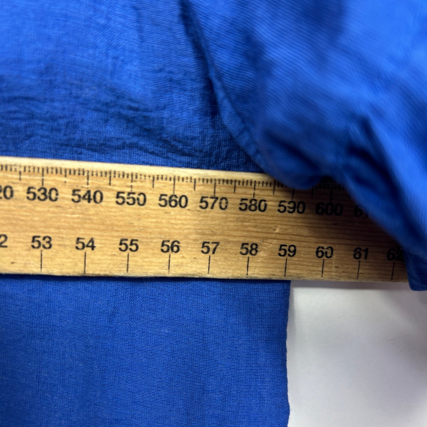 Blue fabric with measuring tape detail view