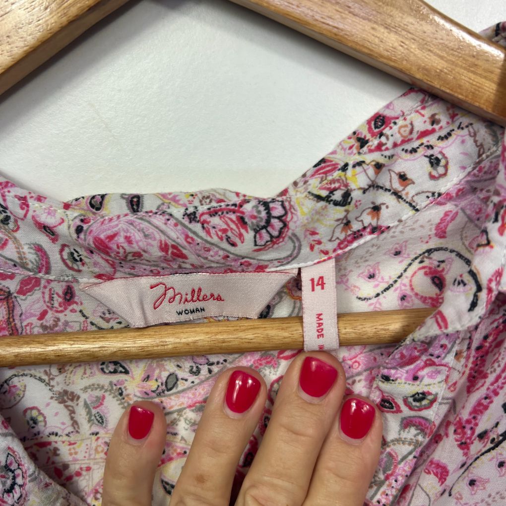 Pink floral fabric detail view with wooden rolling pin and size 14 label