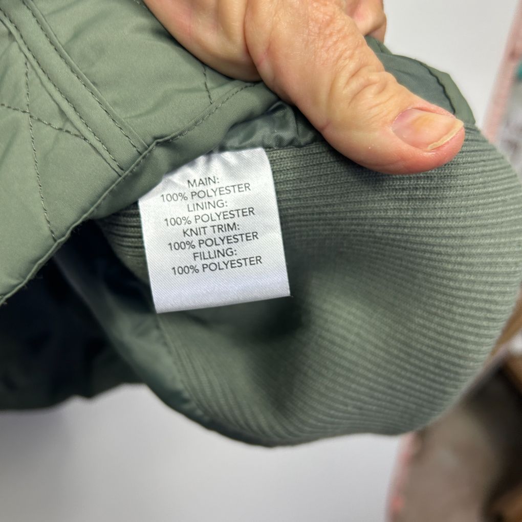 Sage green jacket label detail view