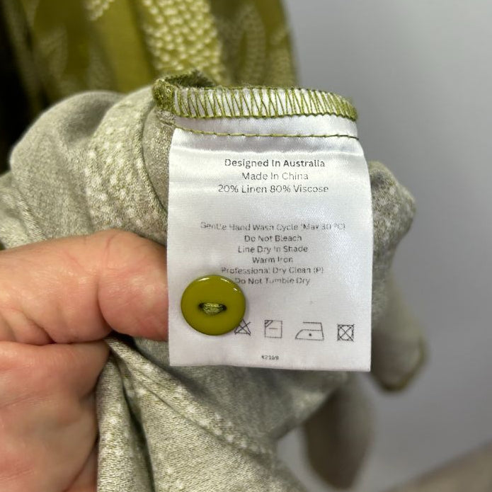Sage green long sleeve top label detail view