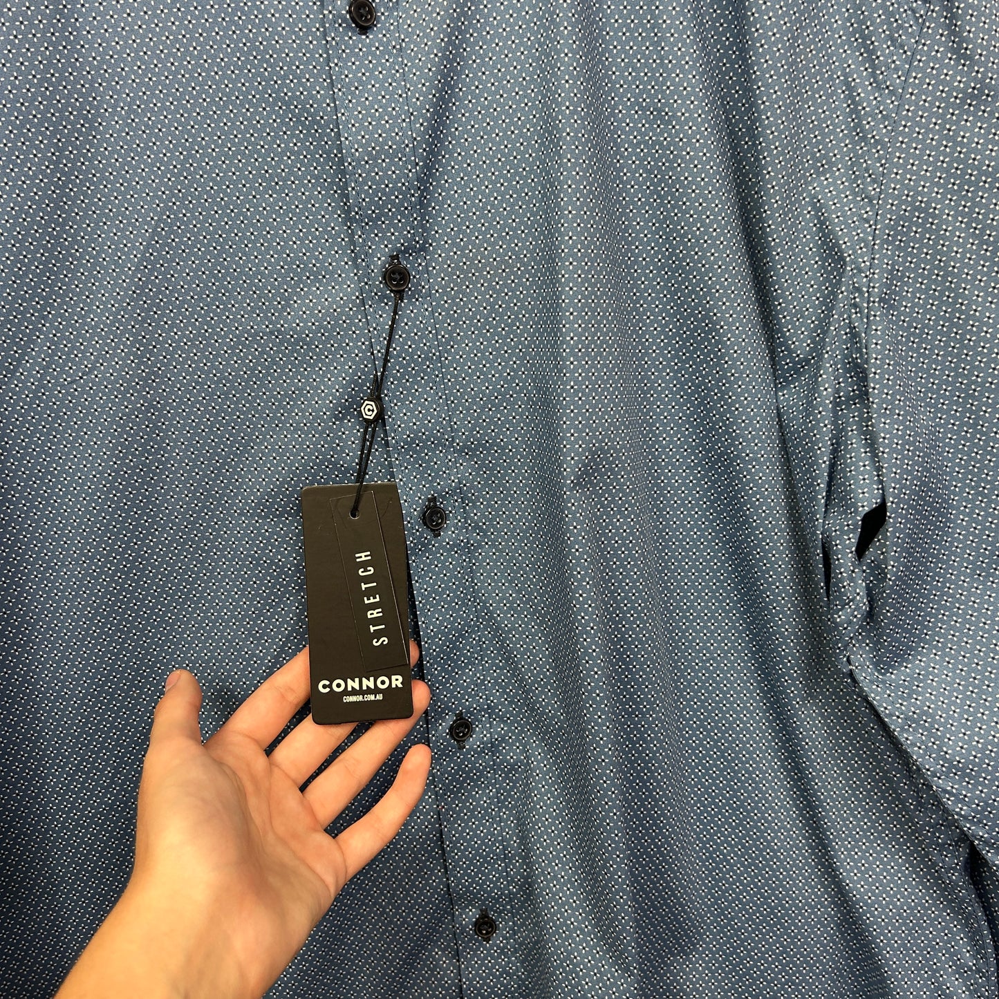 Grey shirt front view with tag detail