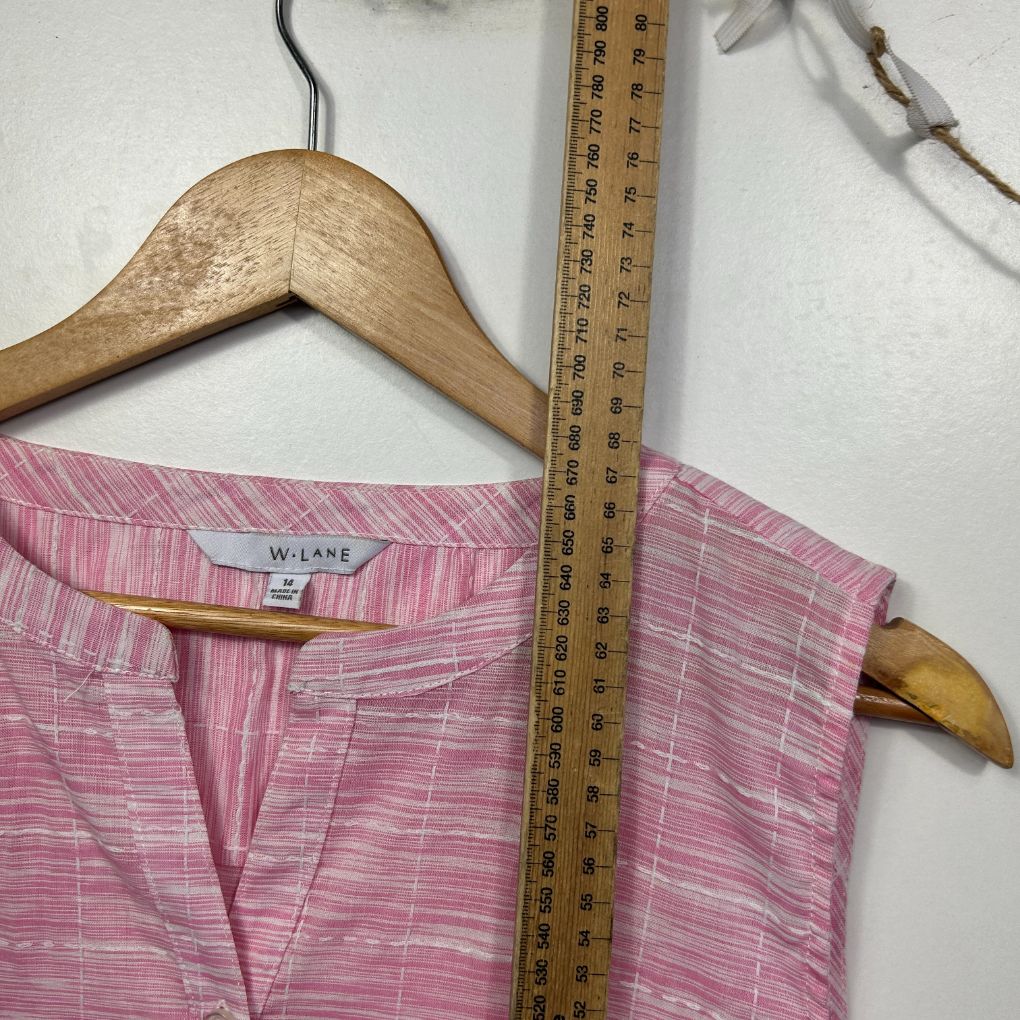 Pink striped shirt front view on wooden hanger with measuring tape