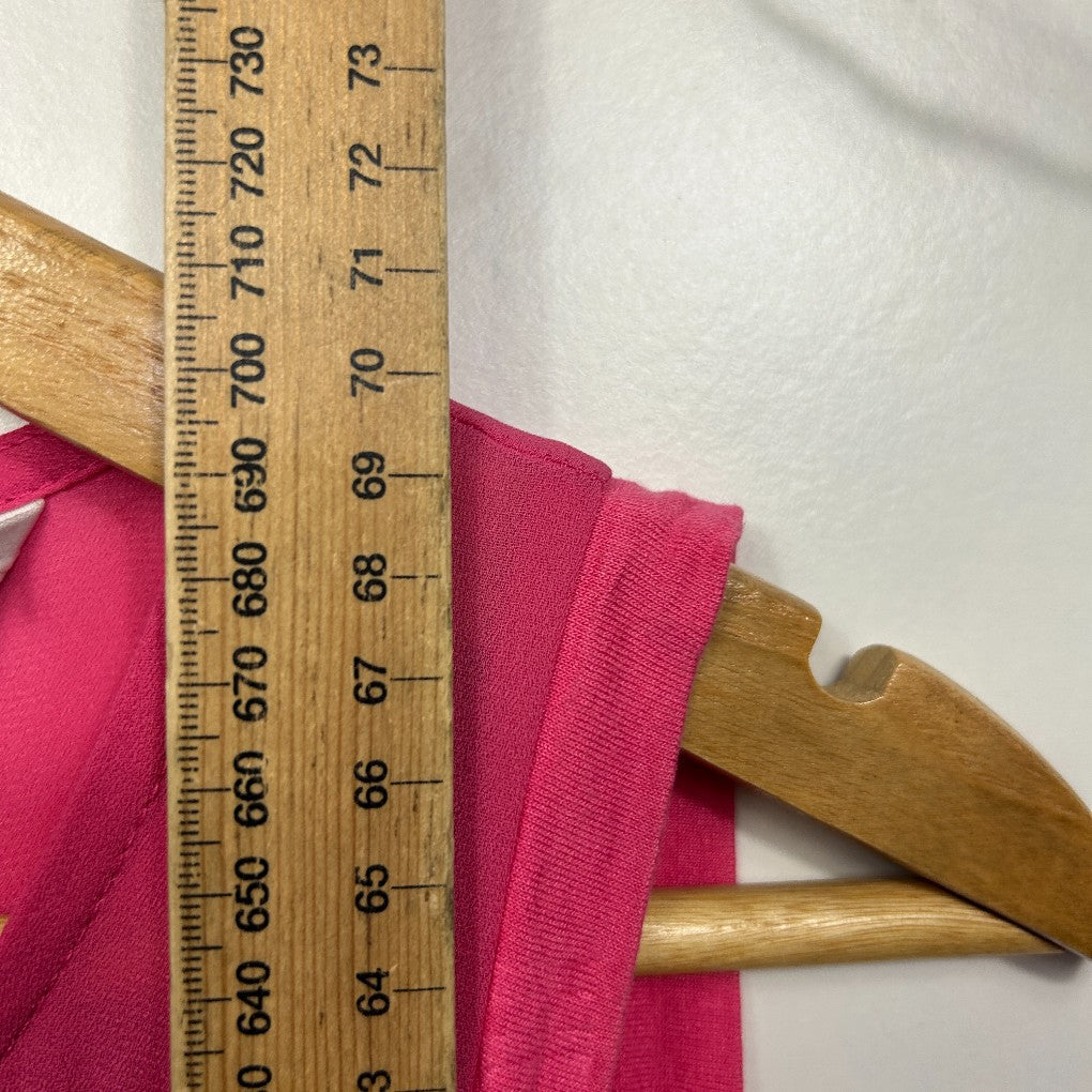 Pink fabric with wooden measuring ruler detail view