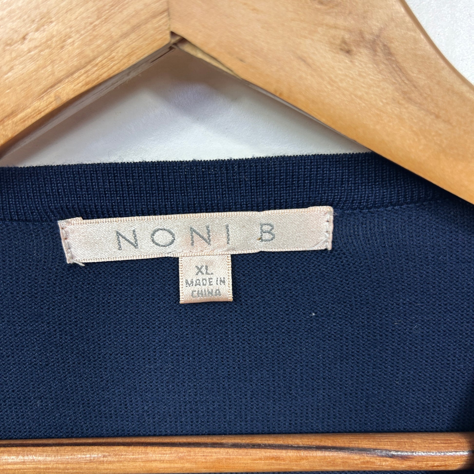 Navy blue garment label detail view
