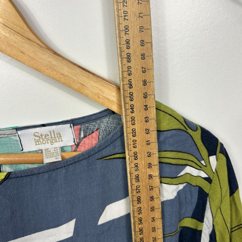 Navy blue top with graphic print front view on wooden hanger