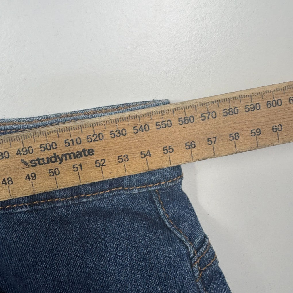 Blue denim jeans with measuring tape detail view
