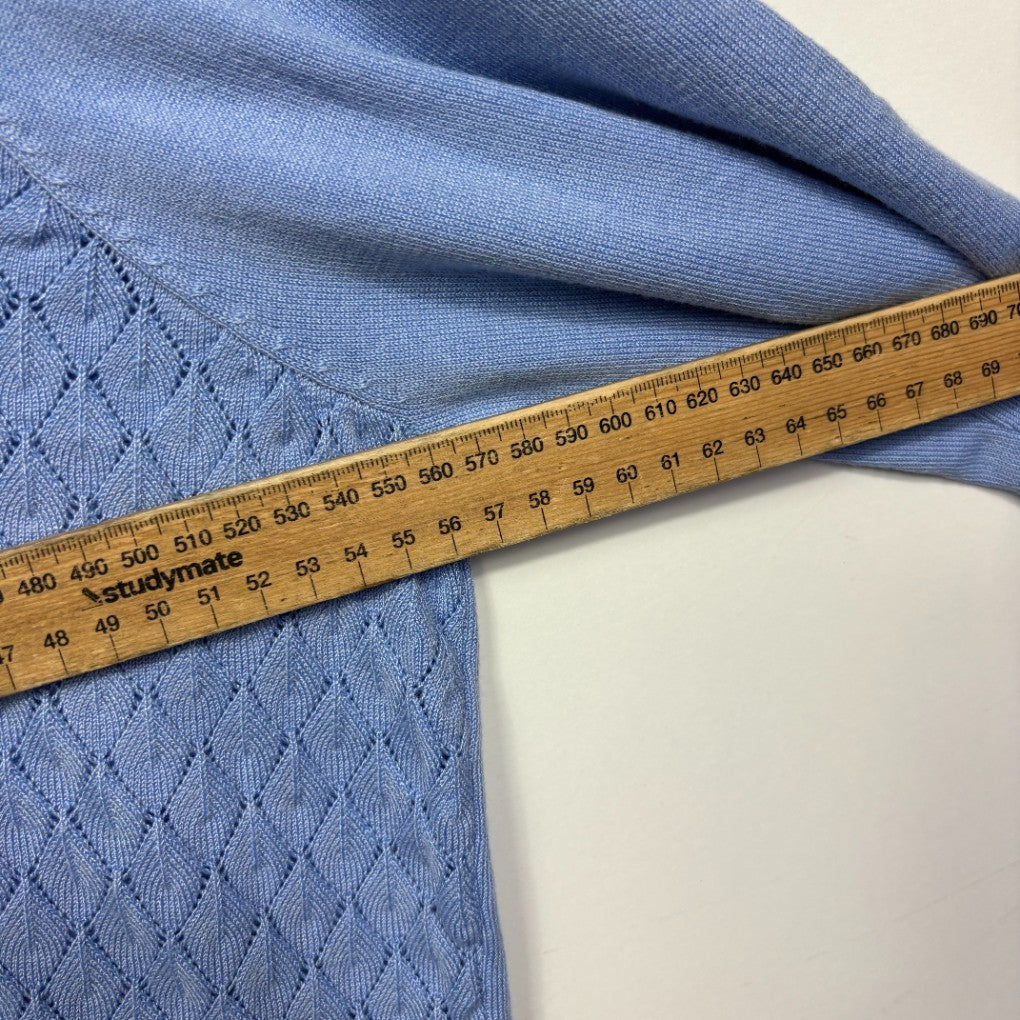 Blue knit fabric detail view with measuring tape