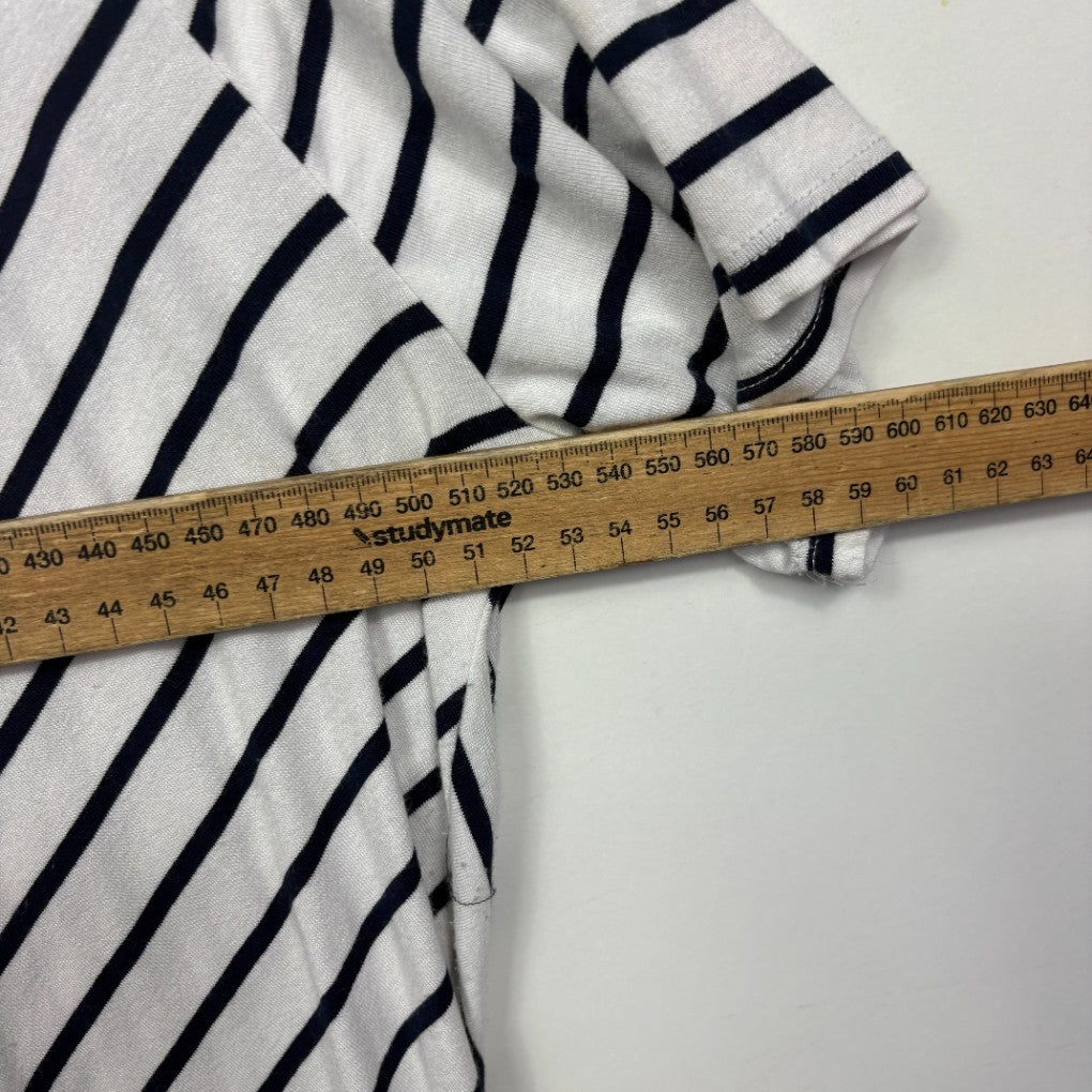 White and navy striped shirt detail view with measuring tape