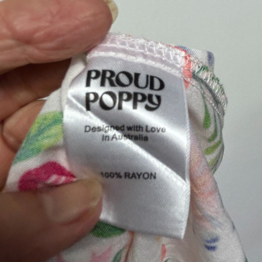 Proud Poppy brand label detail shot showing white tag with black text