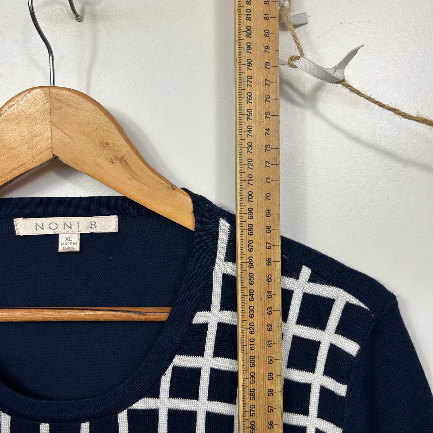 Navy blue long sleeve top with white geometric pattern front view