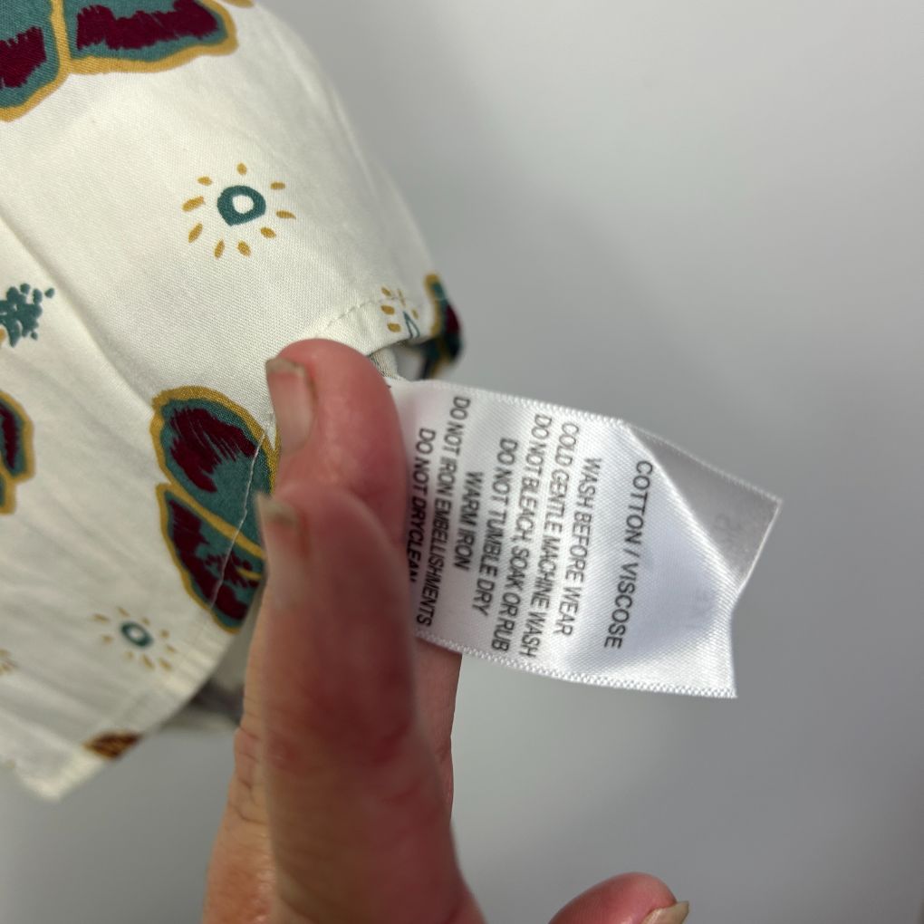 Cream fabric with colorful floral pattern label detail view