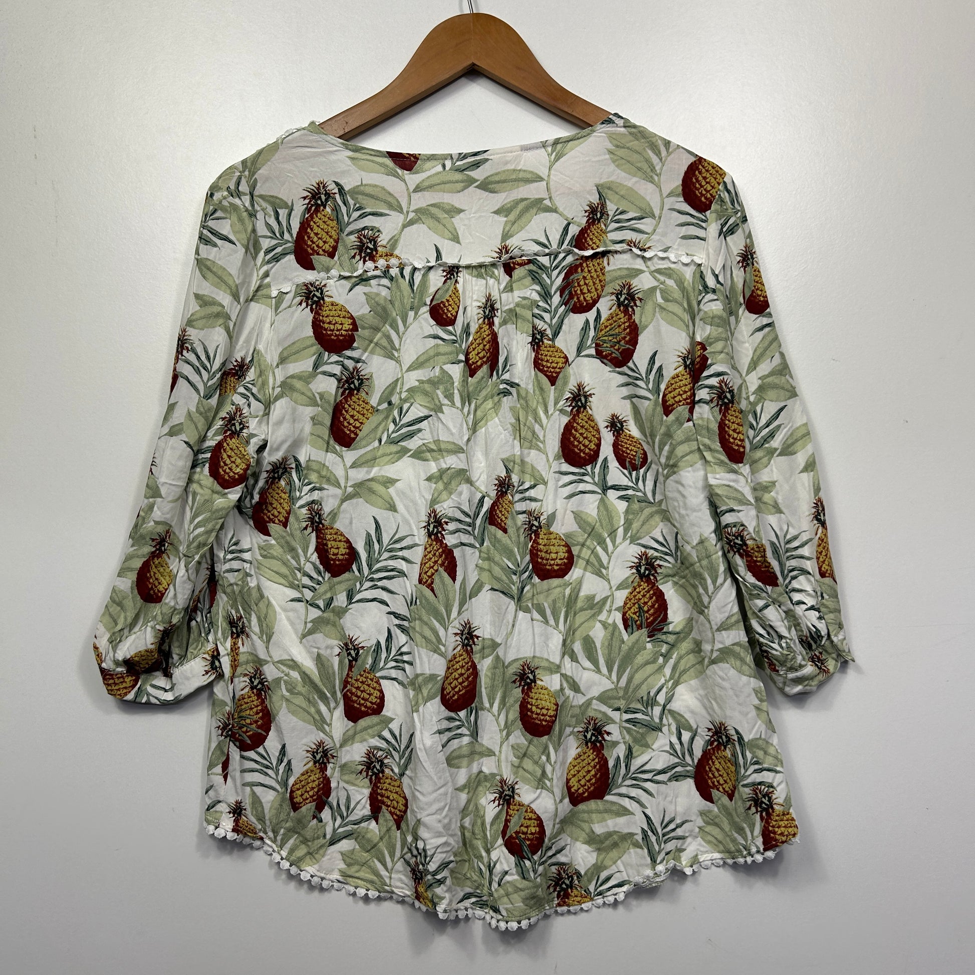 Cream blouse with brown pinecone and green leaf print front view