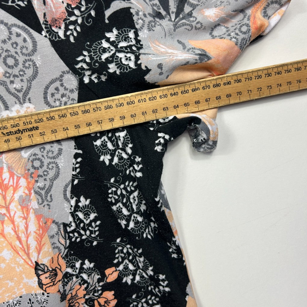 Black and white floral lace dress detail view with measuring tape