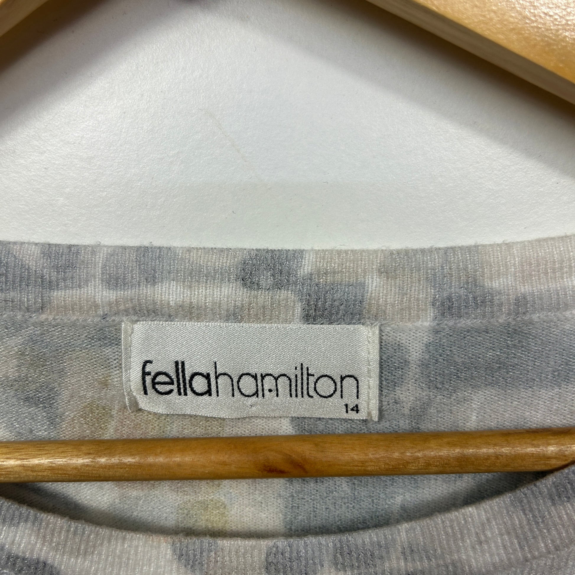 Grey and white striped long sleeve top label detail view