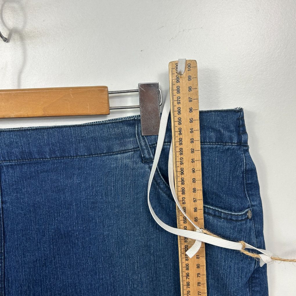 Blue denim jeans detail view with measuring tape