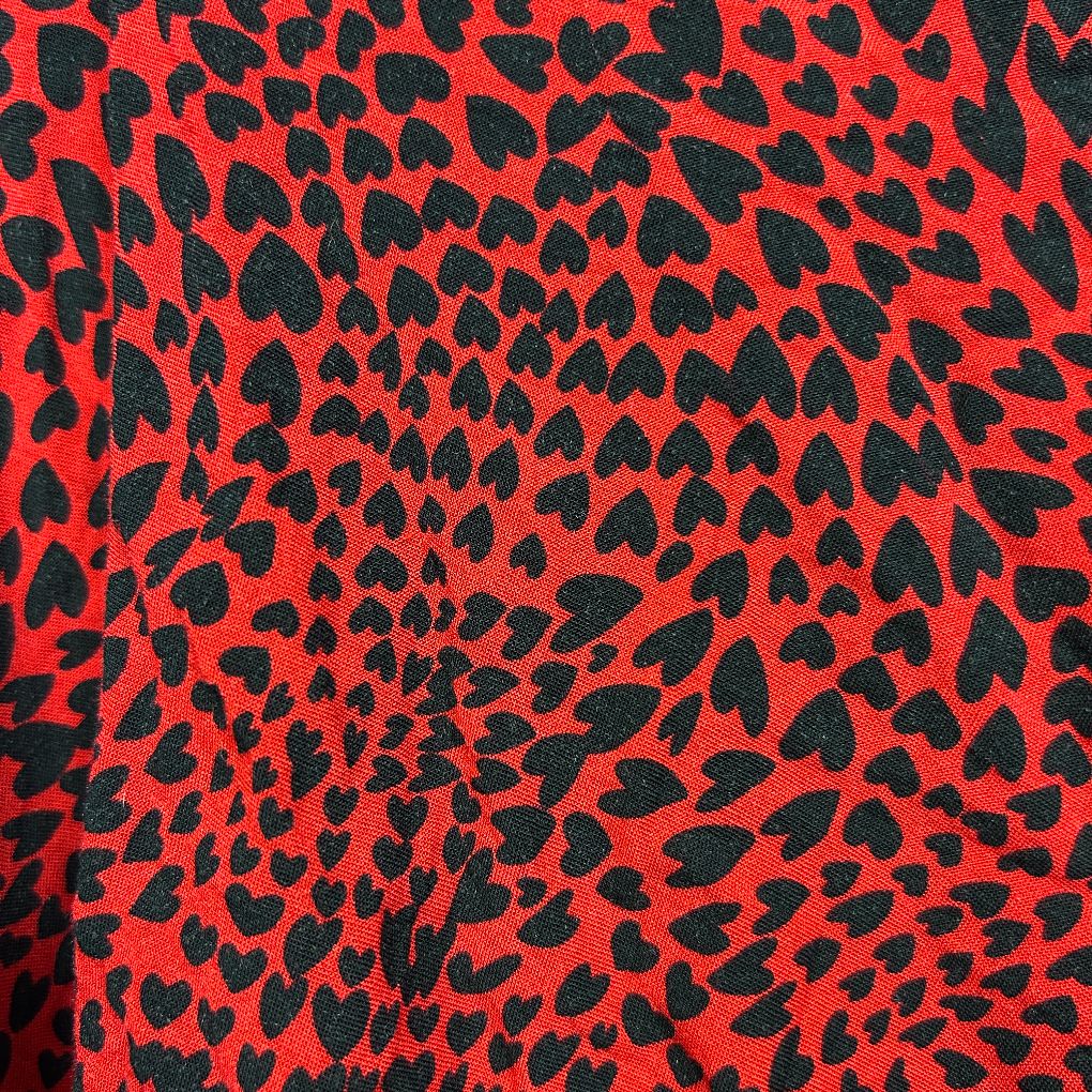 Red and black leopard print fabric detail view