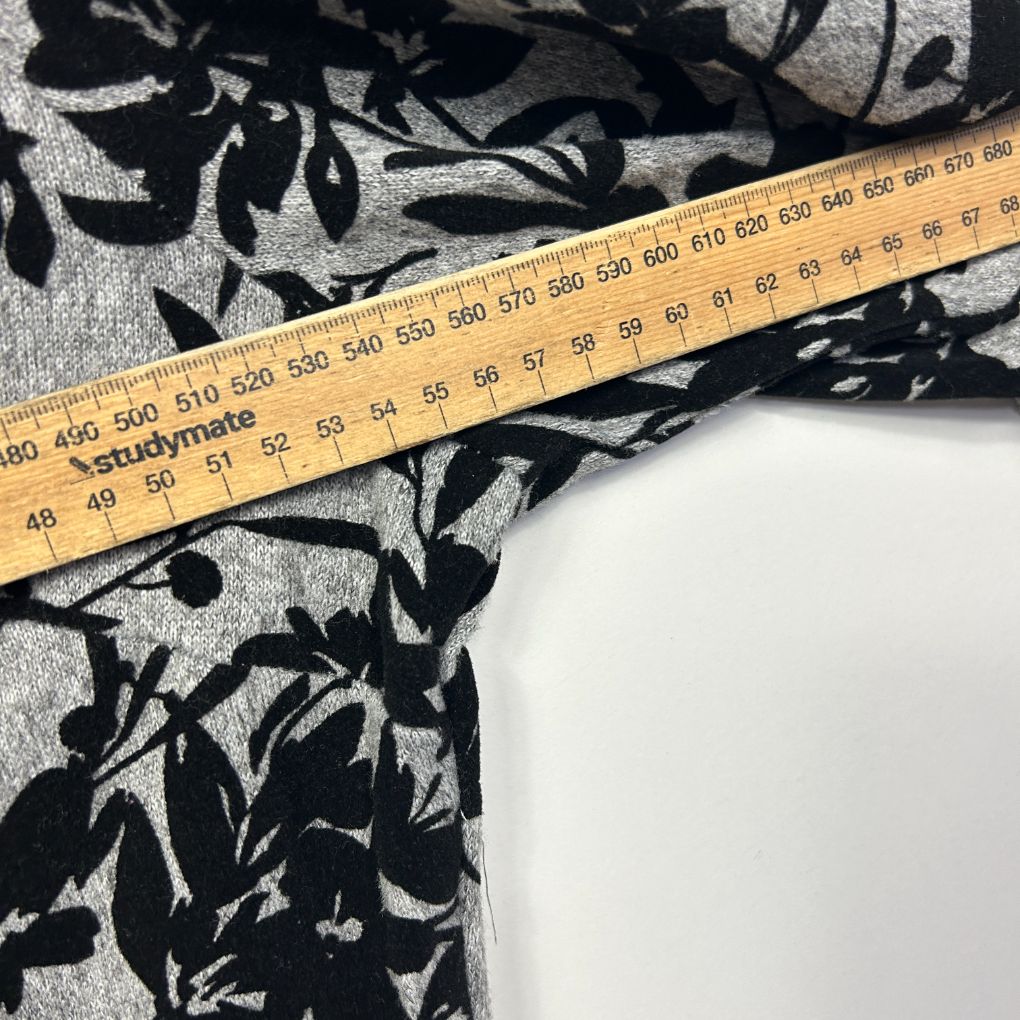 Black and white floral patterned fabric with measuring tape detail view