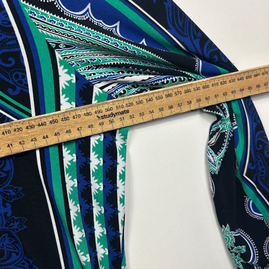 Navy blue paisley fabric detail view with measuring tape