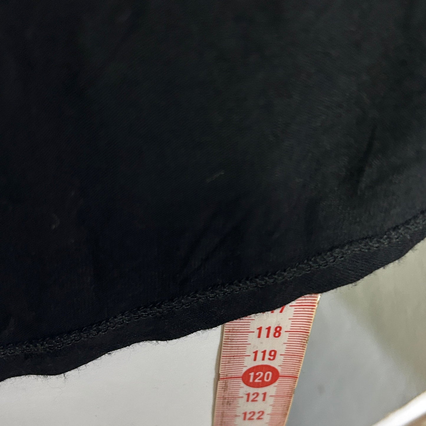 Black top with measurement tape detail view