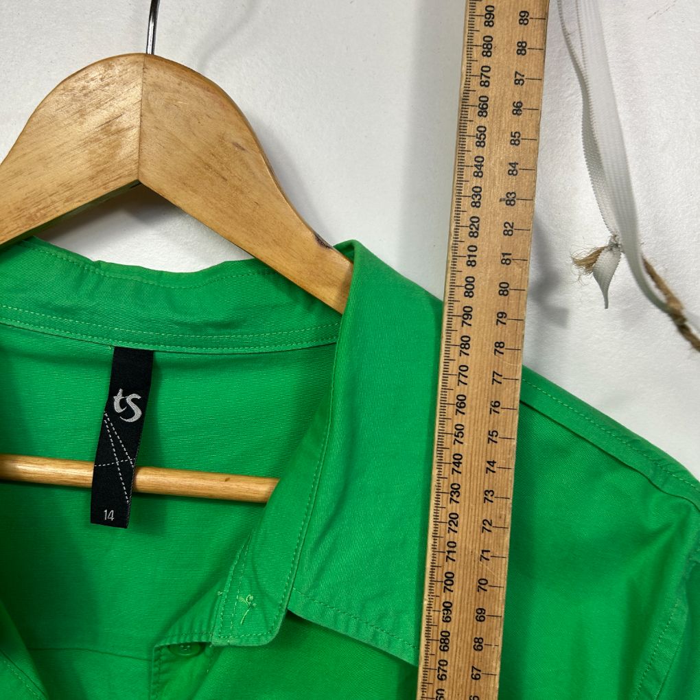 Green shirt front view on hanger with measuring tape