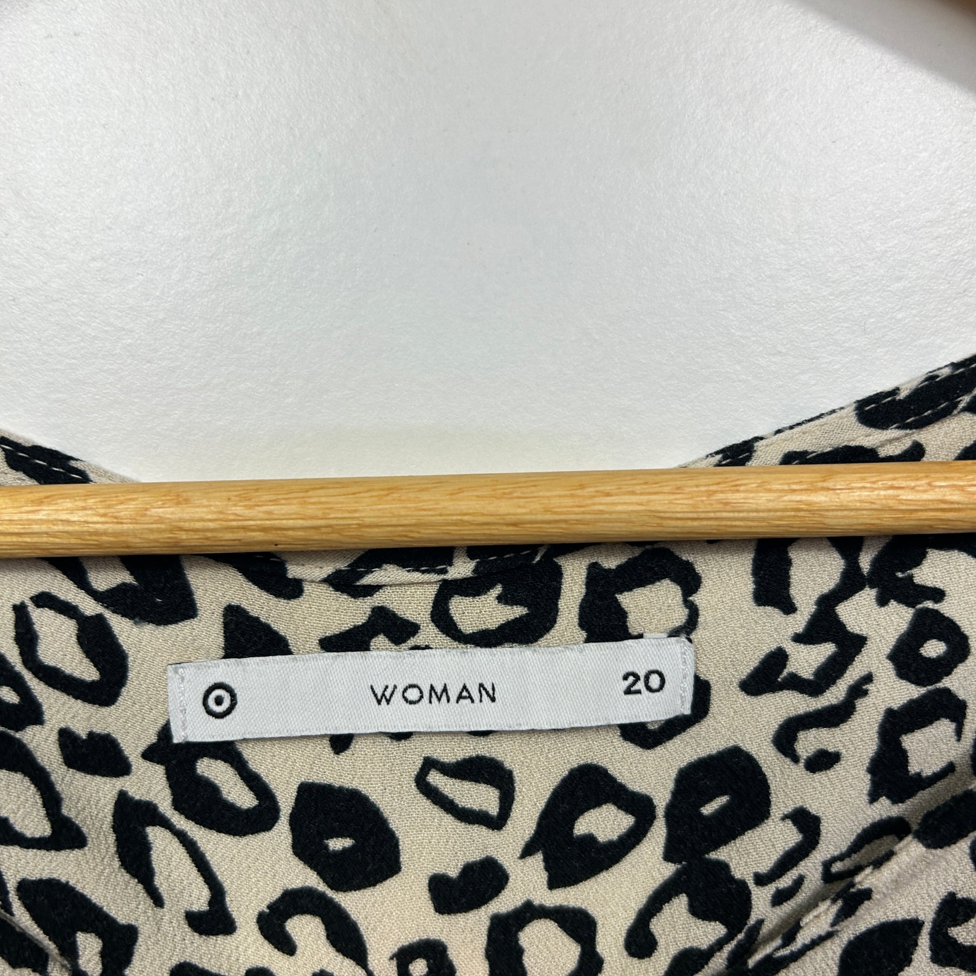 Cream and black leopard print top label view