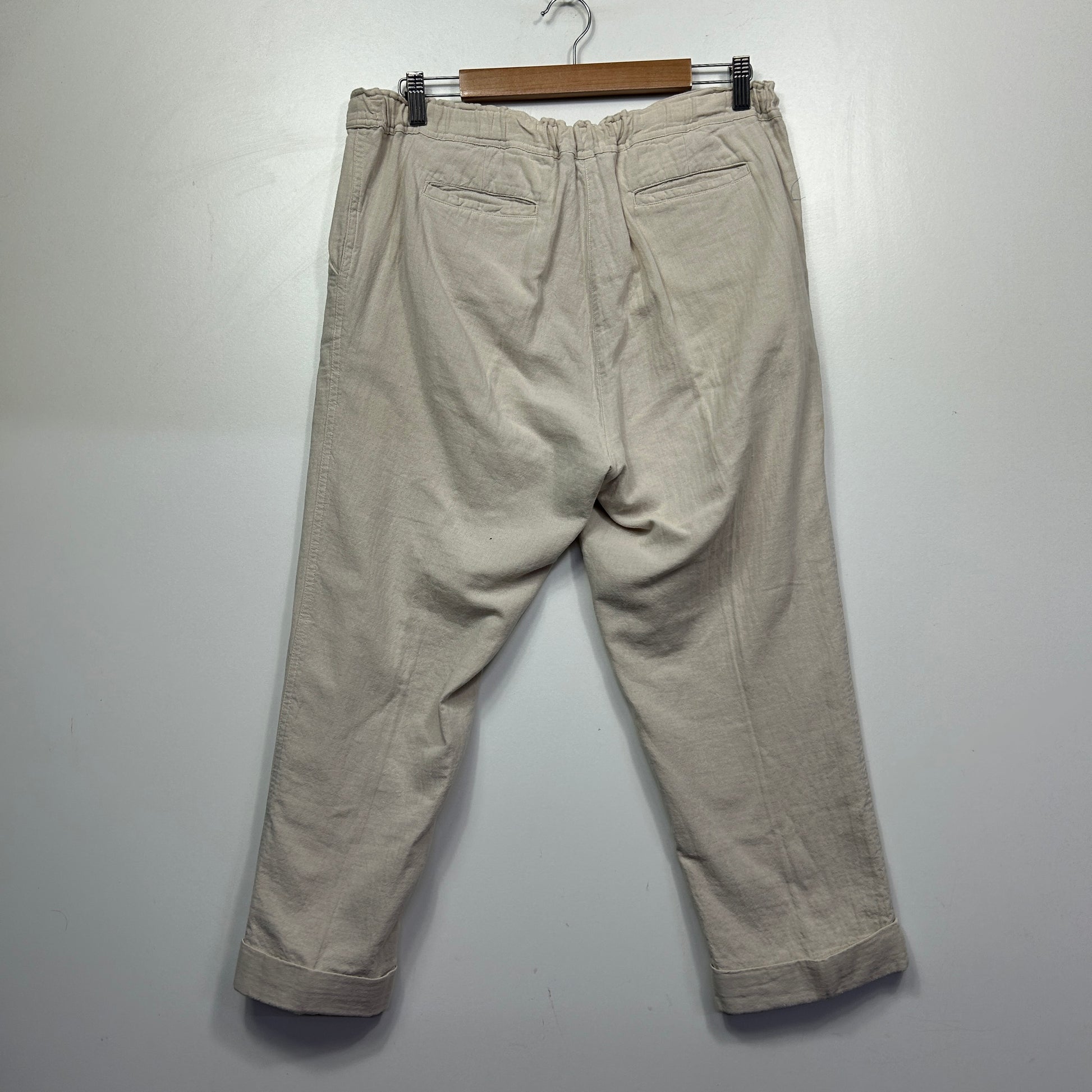Beige chino trousers back view