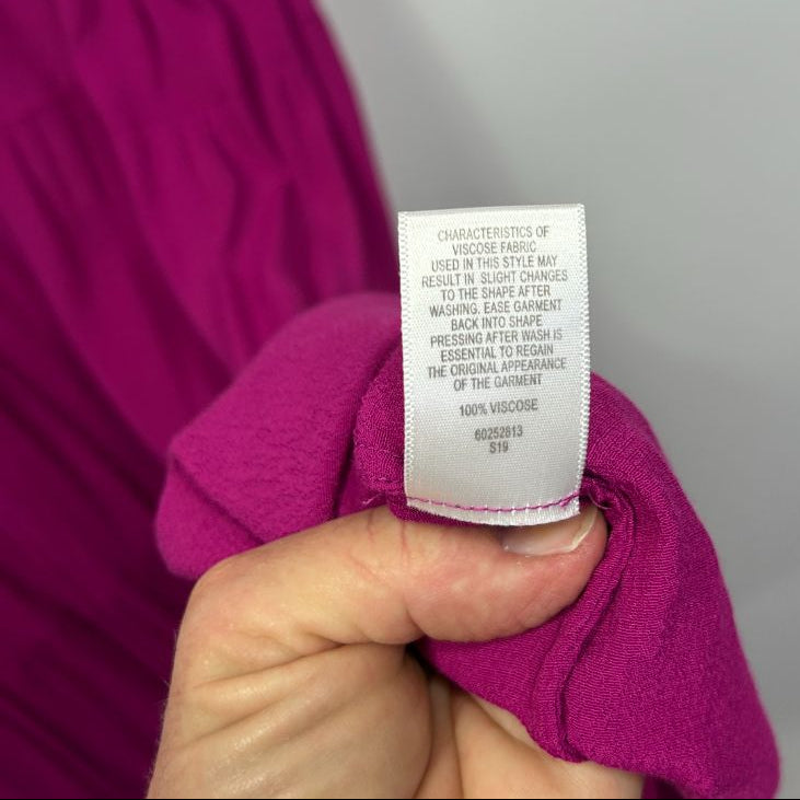 Magenta sweater label detail view