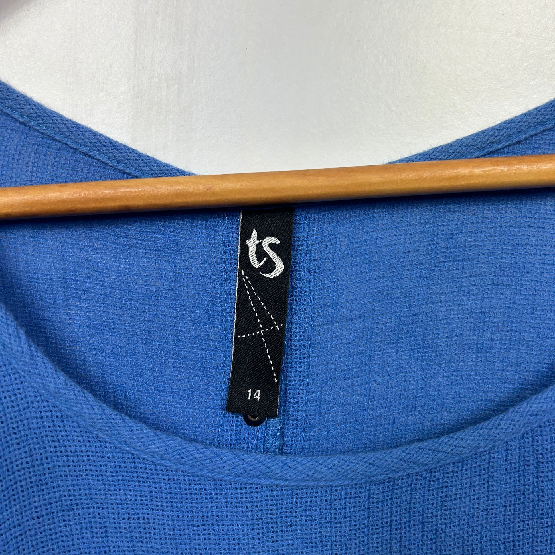 Blue knit top label detail view