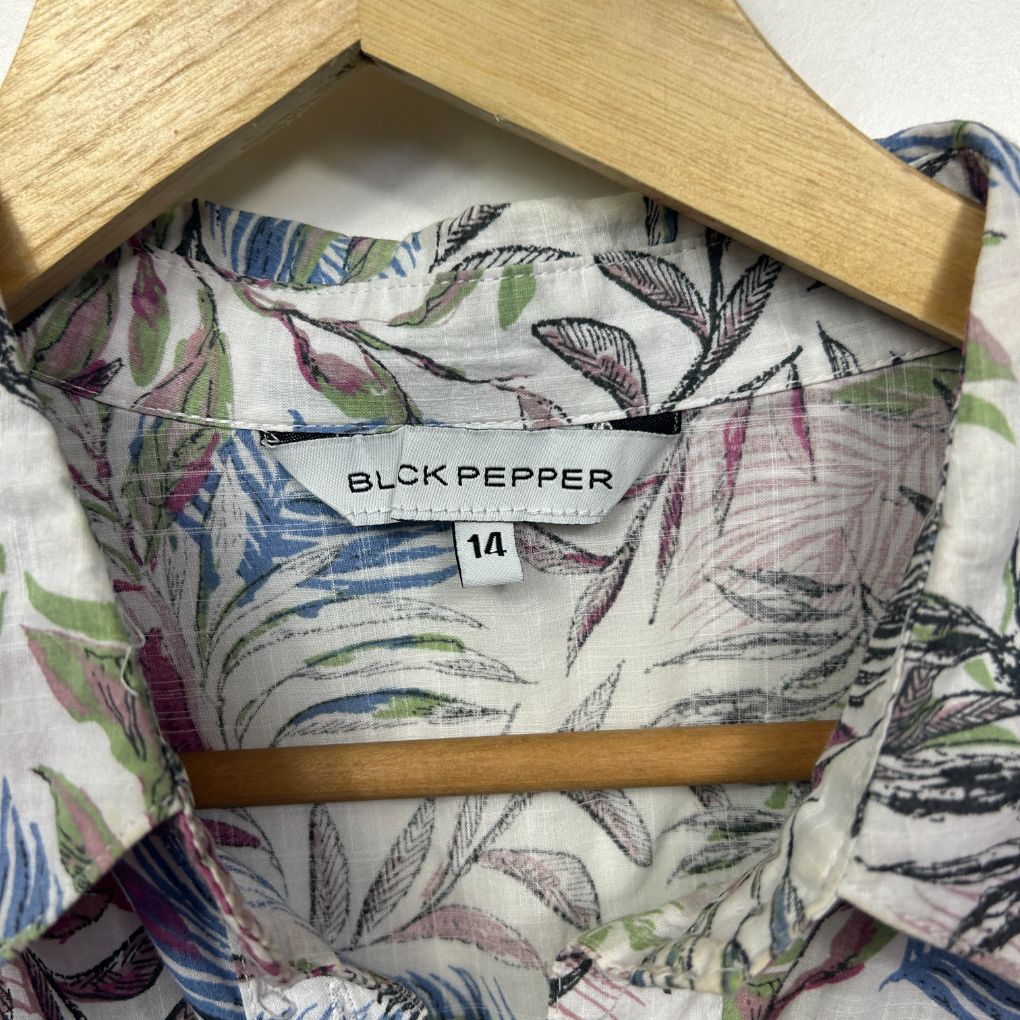 Multicolour floral shirt detail view on wooden hanger