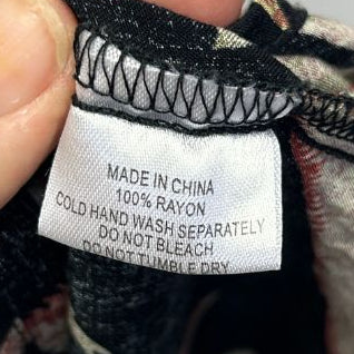 Black knit cardigan label detail view