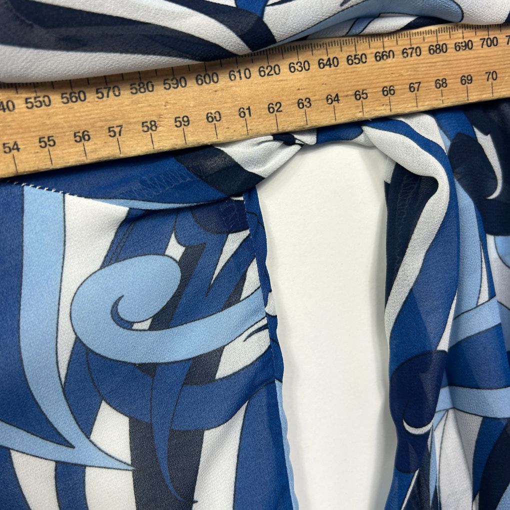 Blue and white graphic print top detail view with measuring tape