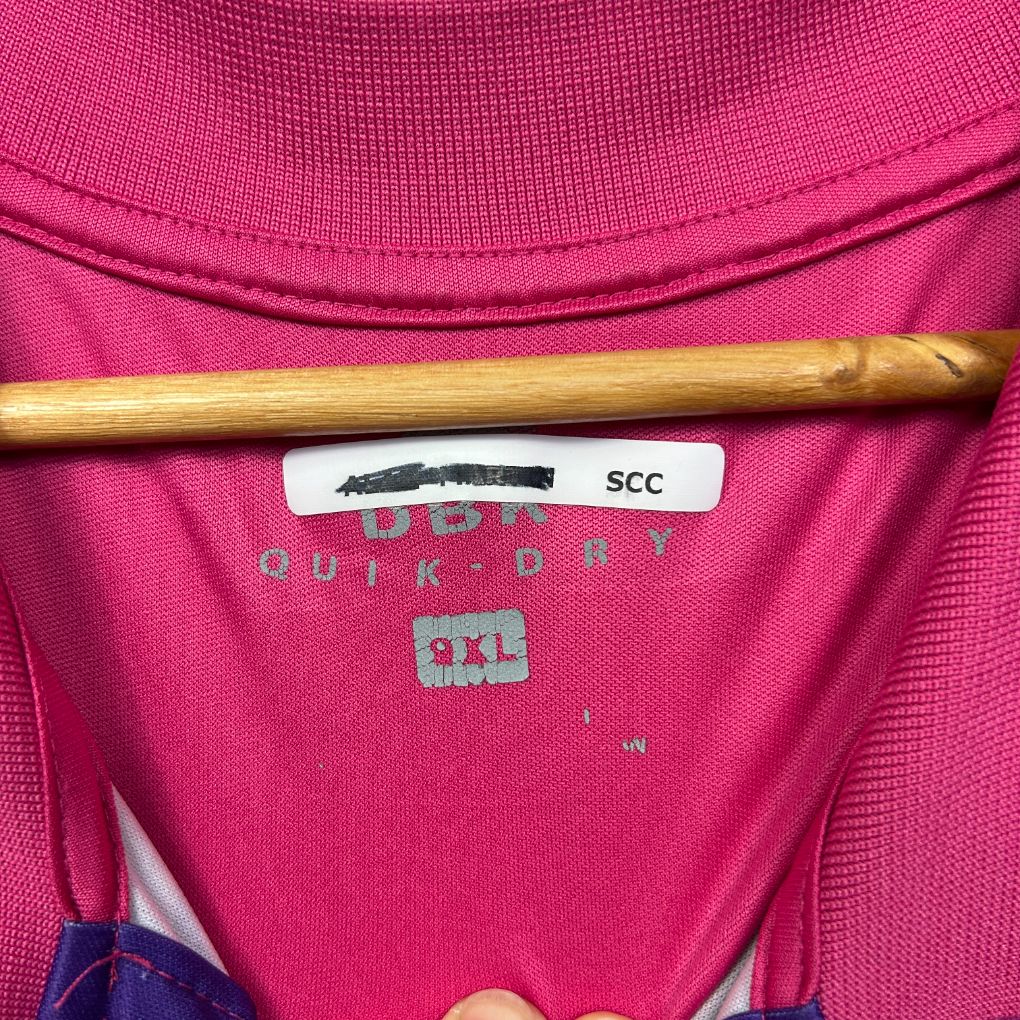 Pink jumper label detail view showing size 9XL