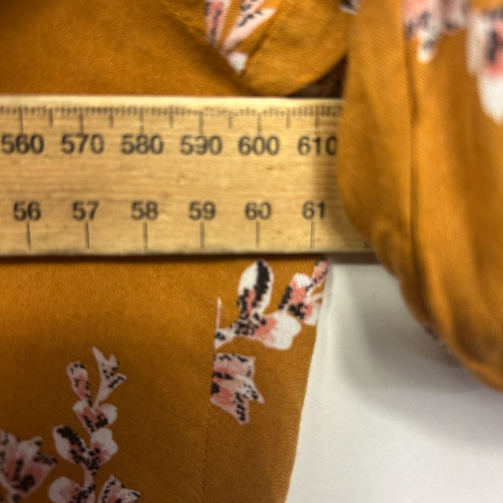 Mustard yellow top with floral embroidery detail view