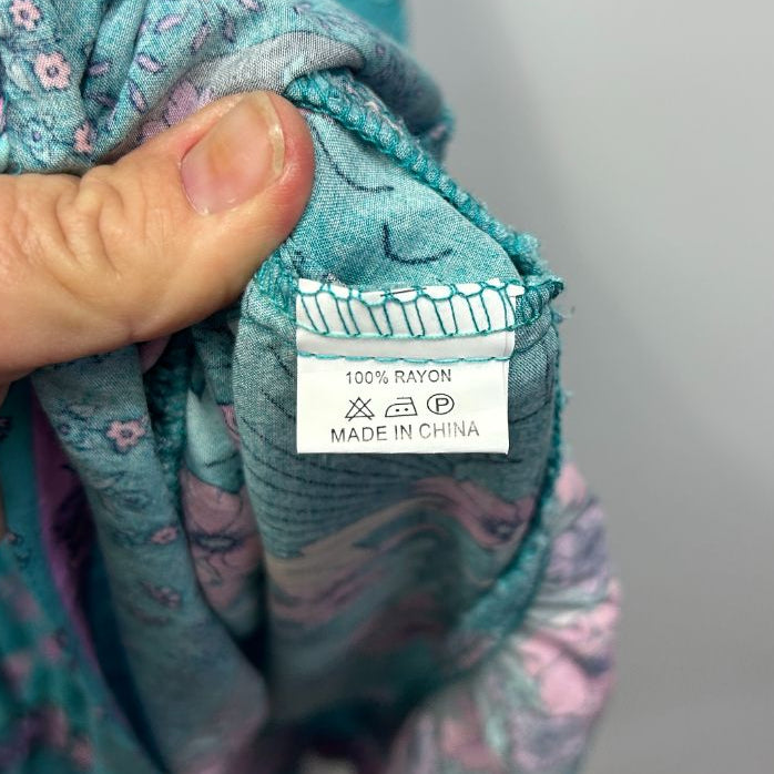 Teal floral jacket label detail view