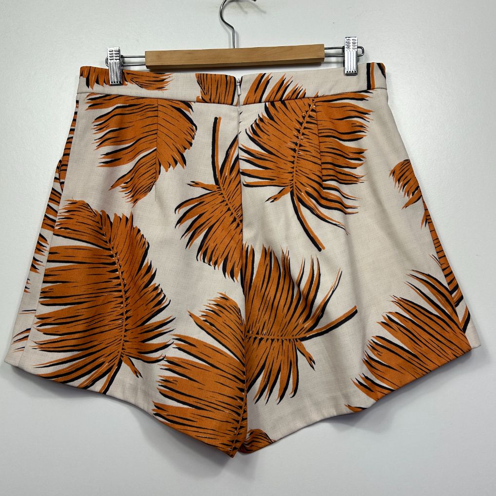 Cream shorts with orange feather print front view
