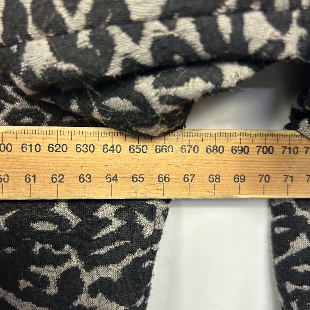 Black and cream patterned knit fabric detail view with ruler measurement