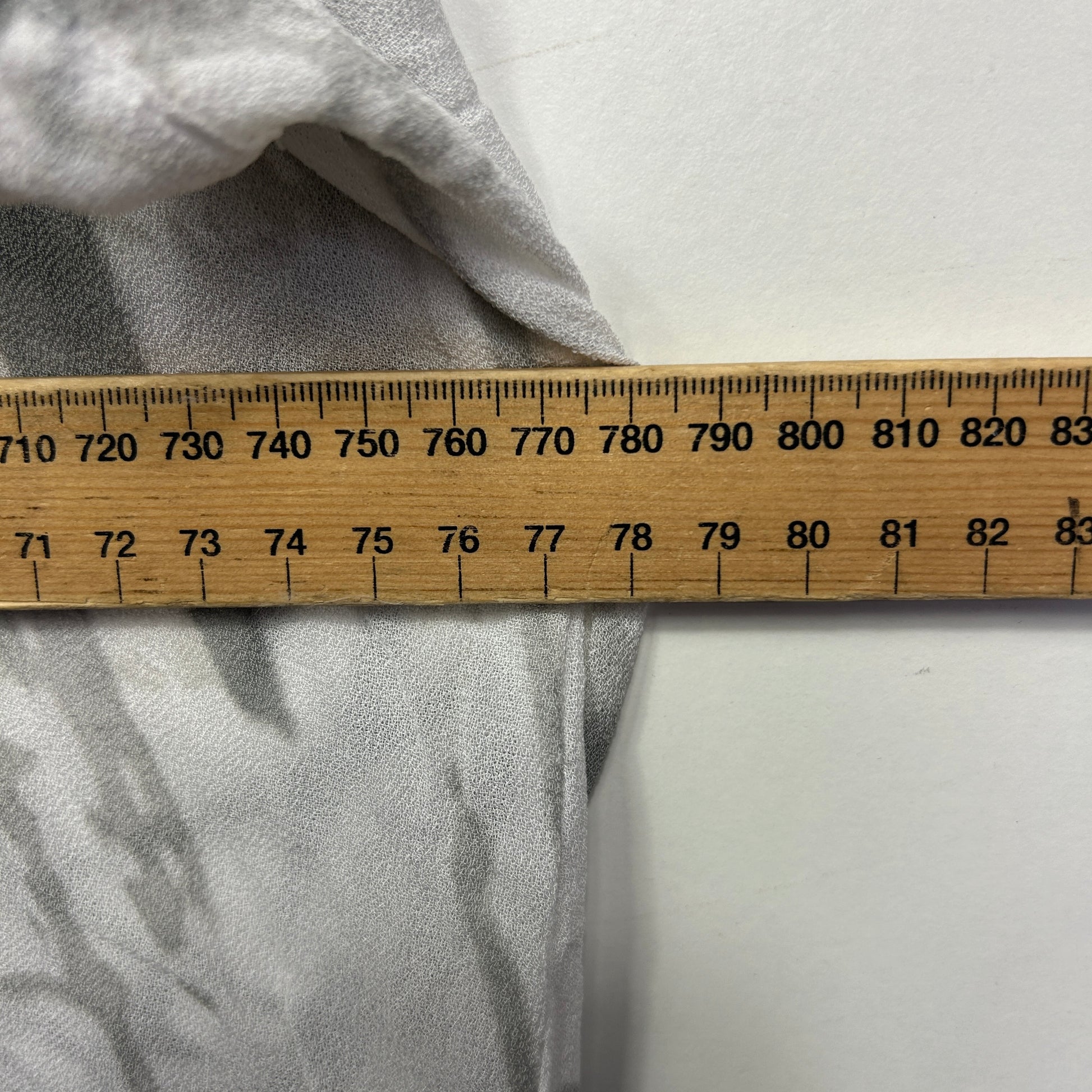 Grey fabric with measuring tape detail view