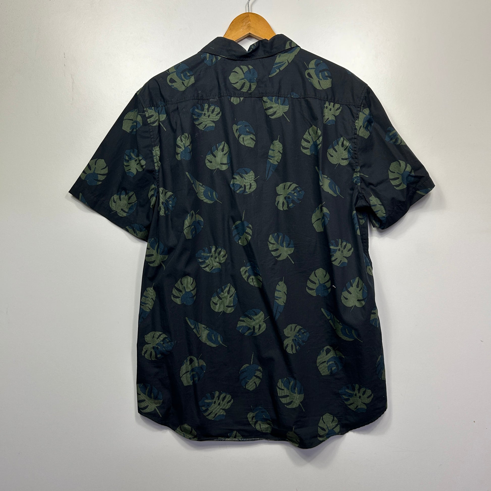 Navy short sleeve shirt with green leaf pattern front view