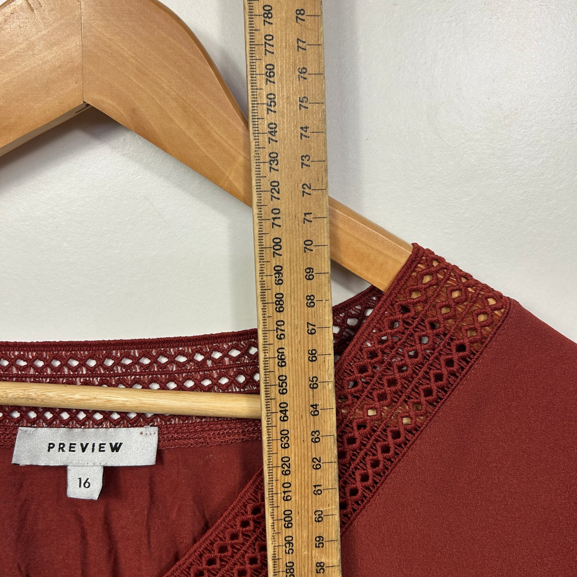 Burgundy top front view with decorative trim detail