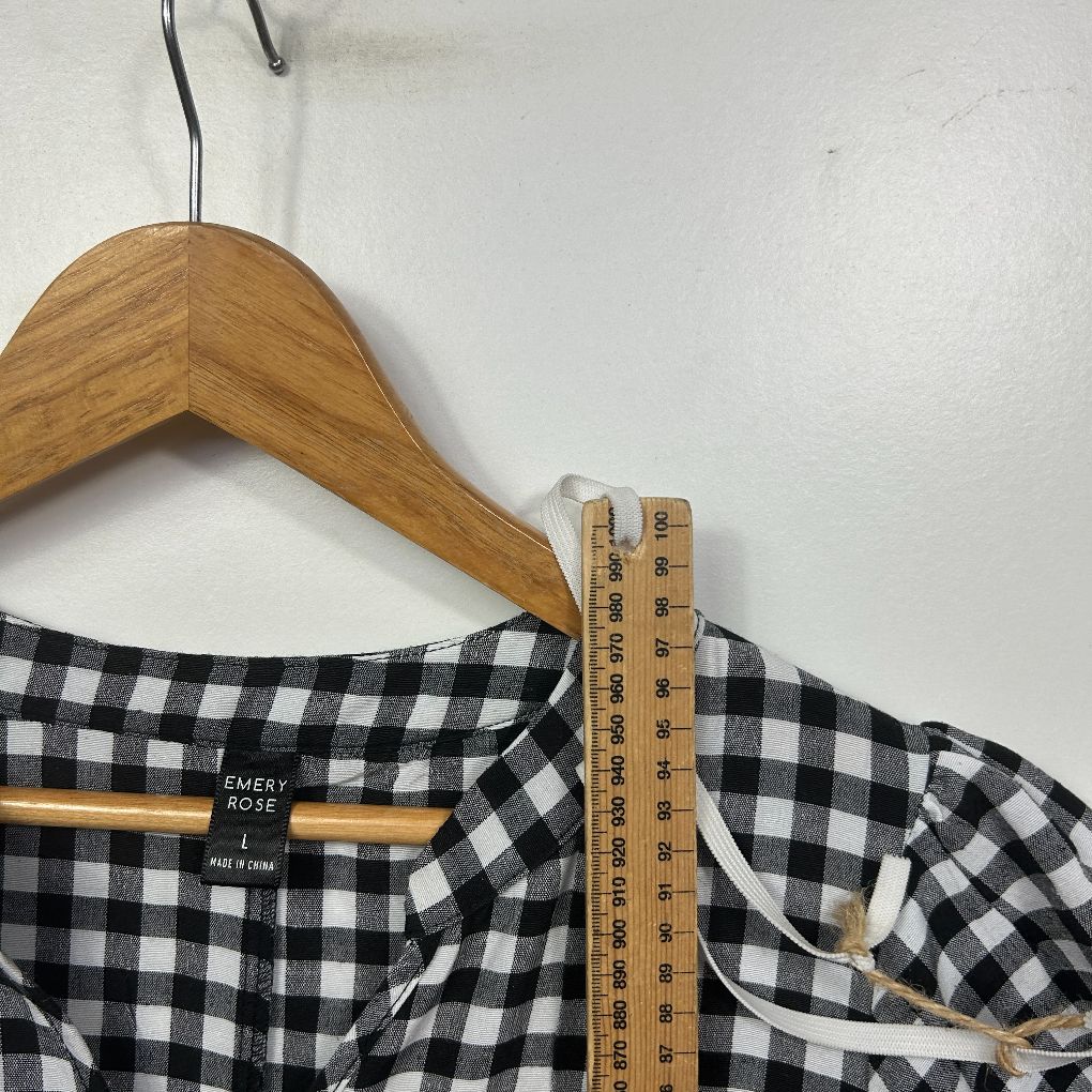 Black and white gingham check top front view on wooden hanger with measuring tape