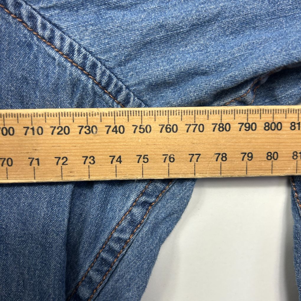 Blue denim jeans detail view with measuring tape