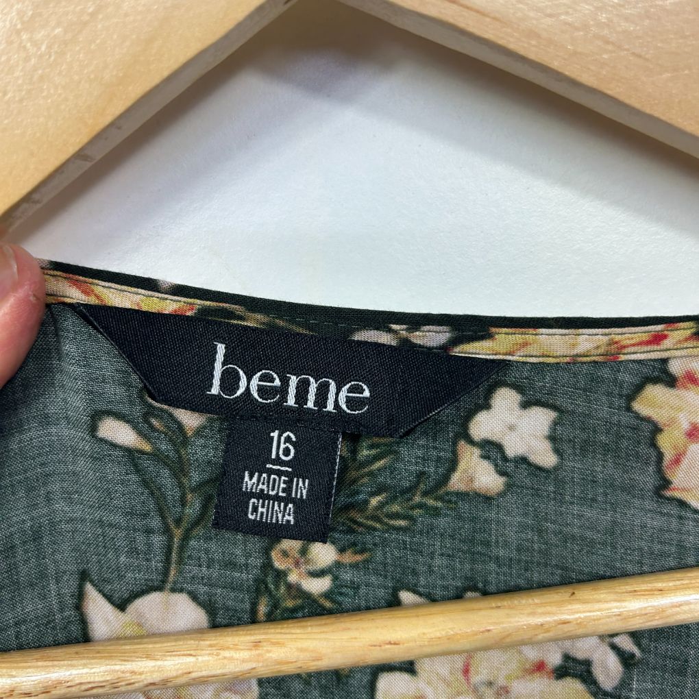 Green floral fabric detail view showing label