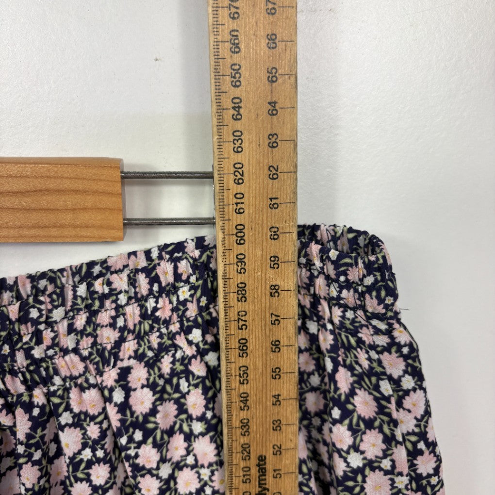 Navy floral print top detail view with measuring tape